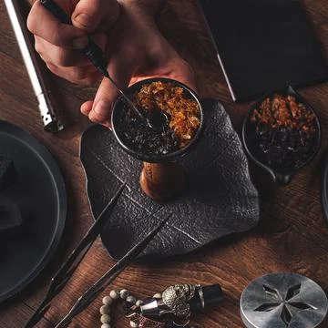 Shisha hookah preparing by barman. Bartender lays tobacco for smoking Stock Photos
