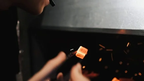 Shisha hookah red hot coals, man blows on a coals, sparks fly. Slow motion. Stock Footage 124647451