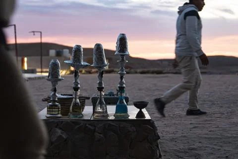 Shisha hookahs on table during desert sunset Stock Photos