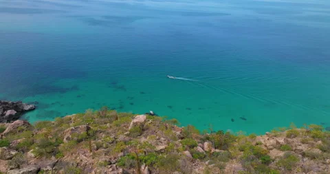 Shoab Coast With Boat Navigating In The Calm, Clear, Blue Water In Socotra Stock Footage 318058628