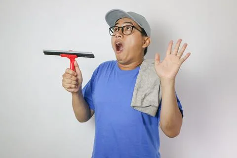 A shock expression cleaning window glass. Cleaning staff and thumb up Stock Photos