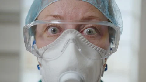 Shock on face of doctor in protective mask and glasses Stock Footage 295429253