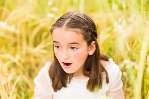 Shocked amazed expression from a communion Hispanic girls religious celebration Stock Photos