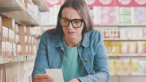 Shocked angry customer checking a shopping receipt Stock Footage 297850608