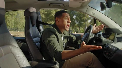Shocked black man driver avoiding car accident on road and expressing irritation Stock Footage 291515098