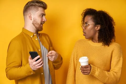 Shocked black woman and man impressed while scroll social media page Stock Photos