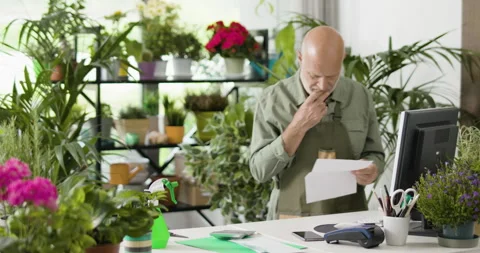 Shocked business owner checking expensive bills Stock Footage 297787958