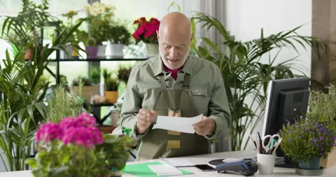 Shocked business owner checking an invoice Stock Footage 297787868