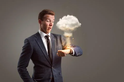 Shocked businessman with an exploding watch Stock Photos