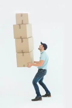 Shocked delivery man carrying stack of boxes Stock Photos