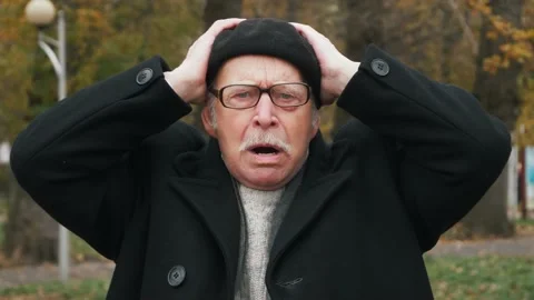 Shocked elderly senior put hands on head and very surprised puts his hands to Stock Footage 143730000
