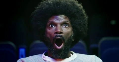 A shocked gasp reaction from a man at the movie theatre. Slow motion. Stock Footage
