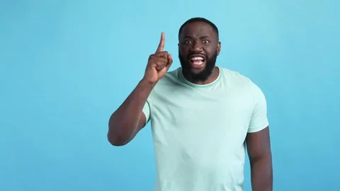 Shocked guy decide thought finger point up isolated blue color background Stock Footage 167691415
