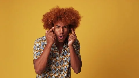 Shocked guy shows with his hands to the side of advertising space isolated on Stock Footage 284953301