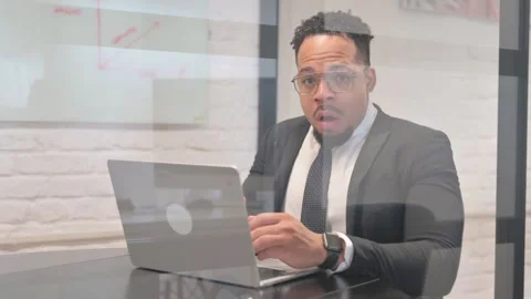 Shocked Hispanic Businessman while Looking at Camera Vidéo 305735962