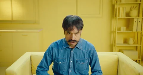 Shocked Hispanic man with a mustache reading unexpected news on the laptop Video stock 171372560