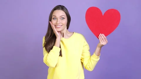 Shocked lady impressed affection card heart isolated vivid color background Video stock 169996909