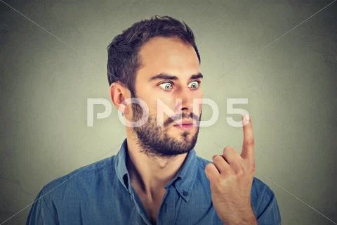 Shocked man looking at his finger Stock Photos