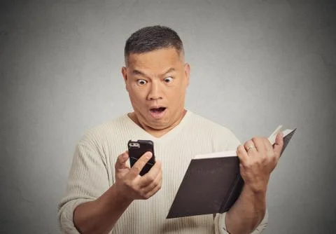 Shocked middle aged man looking at phone Stock Photos