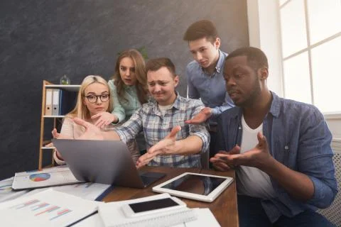 Shocked people gesturing at computer screen Stock Photos