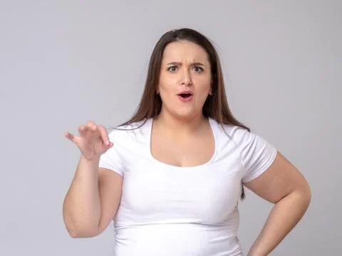 Shocked Plus Size Model with long hair posing in studio Stock Photos