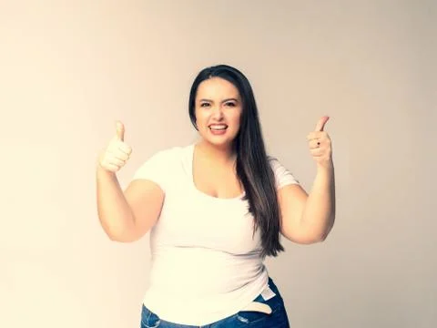 Shocked Plus Size Model with long hair posing in studio. v -sym Stock Photos