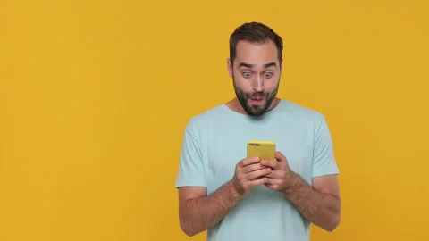 Shocked surprised young man in basic casual blue t-shirt say wow hold in hand Video stock 148291073
