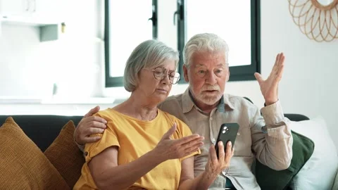 Shocked upset elderly couple getting bad news, finding fraud, money stealing, lo Stock Footage 237939414
