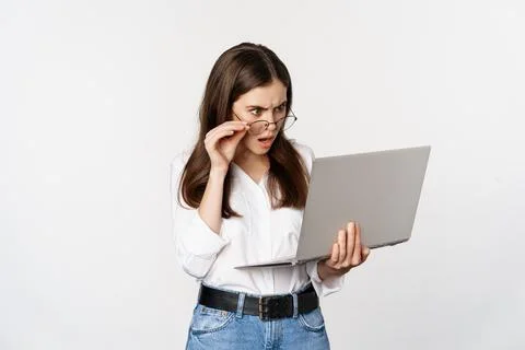 Shocked woman looking at laptop screen confused, stunned about smth on computer Stock Photos