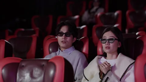 Shocked young couple watching 3d movie experience wearing 3D glasses on Stock Footage 331767268