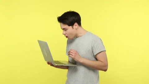 Shocked young man having problems working on laptop, disappointed with data lost Video stock 148357483