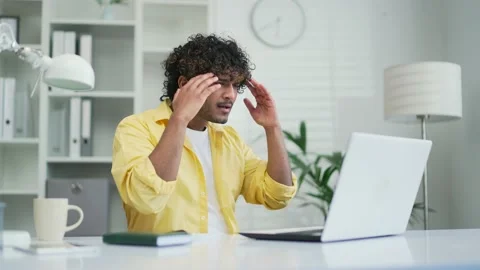Shocked young office worker or freelancer reading bad news looking at laptop  Stock Footage 235485248