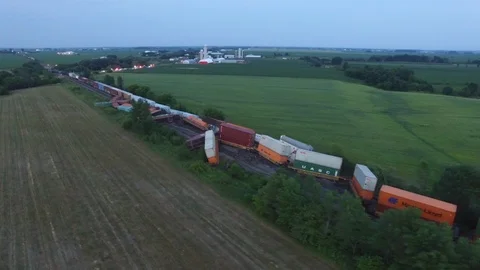 Shocking view of train crash with freight cars fallen of rail tracks at night - Video stock 104075074