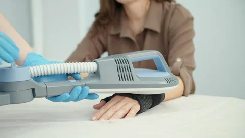 Shockwave therapy applied to patient hand during physiotherapy Stock Footage 325853783