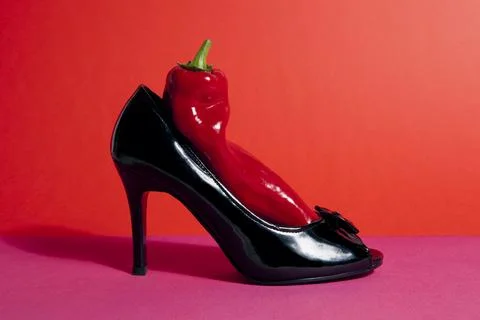Shoe and red pepper inside Stock Photos