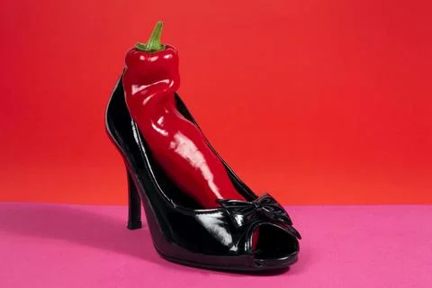 Shoe and red pepper inside Stock Photos