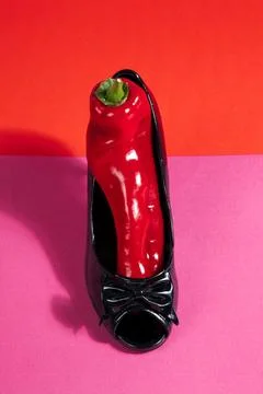Shoe and red pepper inside Stock Photos