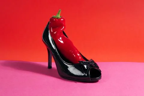 Shoe and red pepper inside Stock Photos