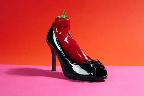 Shoe and red pepper inside Stock Photos