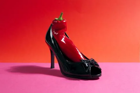 Shoe and red pepper inside Stock Photos
