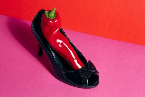 Shoe and red pepper inside Stock Photos
