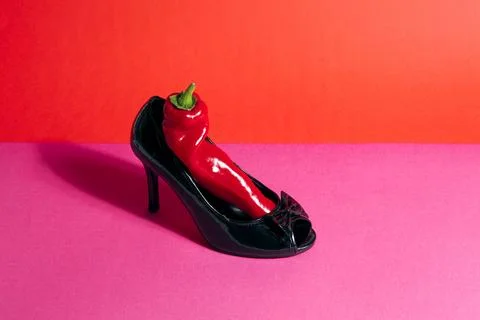 Shoe and red pepper inside Stock Photos