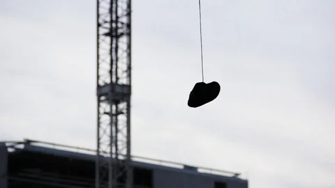 Shoe Hanging From Tree With A Crane In Background Stock Footage 127032385