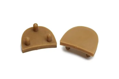 Shoe heeltap plates, replaceable piece, brown, plastic, with ribbed surface.. Stock Photos