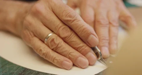 Shoe maker draws outline on material.  Stock Footage 71918289