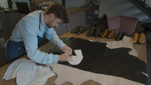 Shoe manufacturing workshop. Shoemaker sews shoes. Handmade work shoes. Leather Video stock 137405562