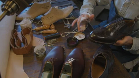 Shoe manufacturing workshop. Shoemaker sews shoes. Handmade work shoes. Leather Stock Footage 137468062
