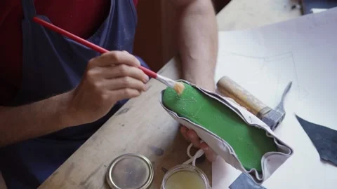 Shoemaker applying glue on plastic last Stock Footage 142549595