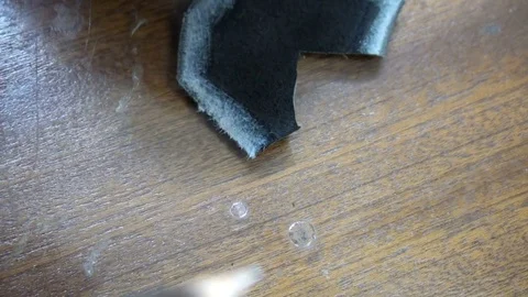 A shoemaker cleans a special knife black leather patch Stock Footage 77873881