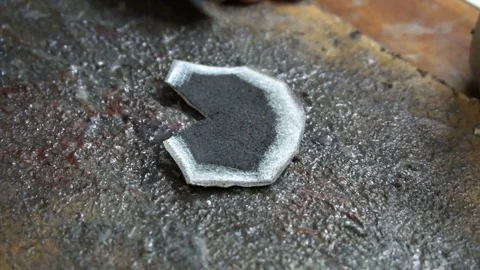 A shoemaker cleans a special knife black leather patch Stock Footage
